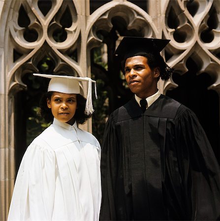 1960s AFRICAN AMERICAN TEENAGE BOY AND GIRL WEARING GRADUATION ROBES Stock Photo - Rights-Managed, Code: 846-03166071