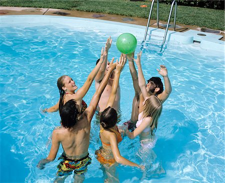 party pool - 1970s GROUP TEENS BOYS GIRLS IN POOL JUMPING AFTER BALL POOL PARTY Stock Photo - Rights-Managed, Code: 846-03166104