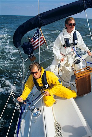 simsearch:846-03163816,k - TWO MEN WEARING FOUL WEATHER GEAR ON SAILBOAT Foto de stock - Con derechos protegidos, Código: 846-03166241