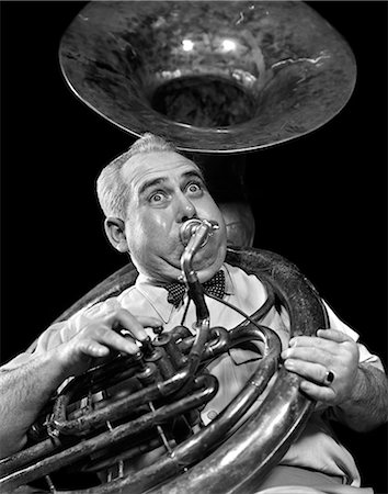 simsearch:846-02794743,k - 1940s CHUBBY MAN MUSICIAN WITH POLKA DOT BOW TIE AND BULGING EYES PLAYING A SOUSAPHONE Stock Photo - Rights-Managed, Code: 846-03166345