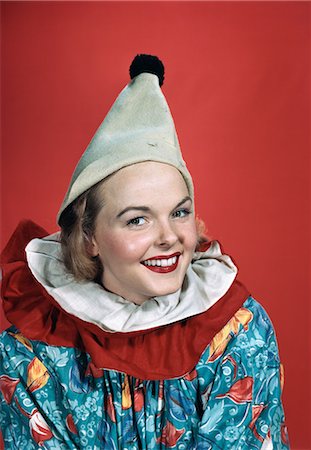 1940s 1950s PORTRAIT SMILING WOMAN WEARING CLOWN OUTFIT POINTED HAT POM POM RUFFLED COLLAR Stock Photo - Rights-Managed, Code: 846-03166353