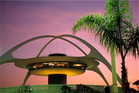 1990s PALM TREE AND ARCHES OF THE FUTURISTIC THEME BUILDING AND RESTAURANT AT LOS ANGELES AIRPORT CALIFORNIA Stock Photo - Rights-Managed, Code: 846-03163156