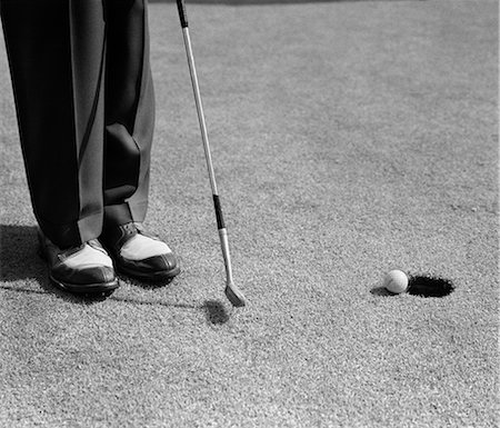 1950s MAN KNEES DOWN PUTT ON GOLF GREEN Stock Photo - Rights-Managed, Code: 846-03163303