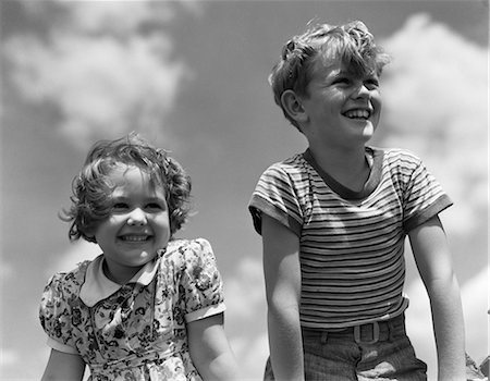 1930s SMILING BOY AND GIRL BRIGHT SUMMER DAY SKY WITH CLOUDS Stock Photo - Rights-Managed, Code: 846-03163401