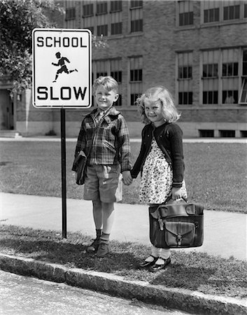 retro school - 1930s 1940s BOY GIRL HOLDING HANDS NEXT TO SCHOOL SLOW SIGN Stock Photo - Rights-Managed, Code: 846-03163427