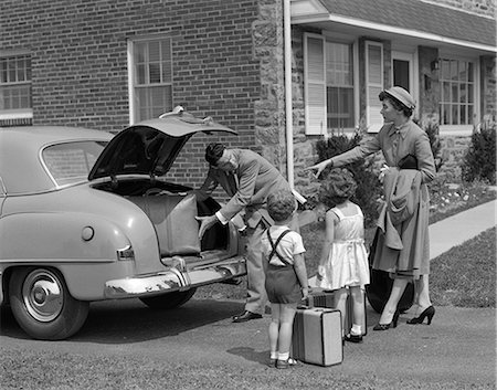 1950s FAMILY PUTTING LUGGAGE SUITCASES INTO TRUNK OF CAR Stock Photo - Rights-Managed, Code: 846-03163494