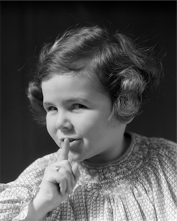 1930s CHILD WITH FINGER TO LIPS Stock Photo - Rights-Managed, Code: 846-03163526