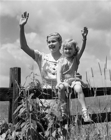 retro mom and child - 1930s GIRL SITTING ON FENCE WITH WOMAN NEXT TO HER IN FIELD WAVING Stock Photo - Rights-Managed, Code: 846-03163573