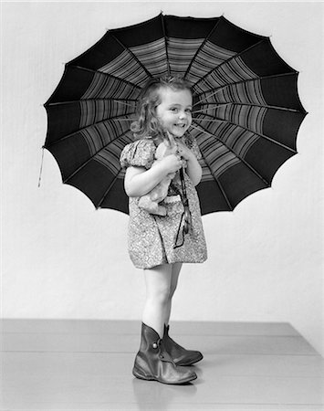 1930s CHILD HOLDING RAINY DAY UMBRELLA Stock Photo - Rights-Managed, Code: 846-03163583