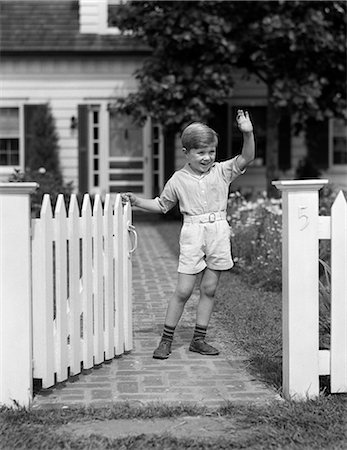 1940s CHILD STANDING NEAR FENCE WAVING Stock Photo - Rights-Managed, Code: 846-03163594