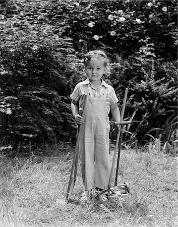 simsearch:846-03163297,k - 1940s CHILD HOLDING LAWN TOOLS WORK CLOTHES GRASS Stock Photo - Rights-Managed, Code: 846-03163611