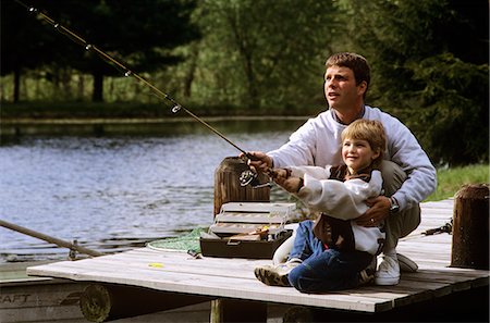 FATHER AND SON FISHING ON DOCK MAN AND BOY Foto de stock - Con derechos protegidos, Código: 846-03163688