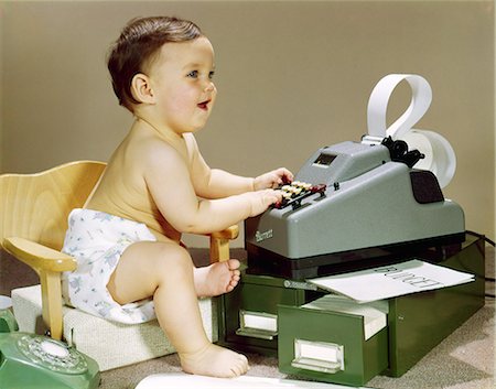 simsearch:846-03163891,k - 1960s BABY WEARING CLOTH DIAPER SITTING IN BOOSTER CHAIR USING ADDING MACHINE CALCULATOR Fotografie stock - Rights-Managed, Codice: 846-03163888