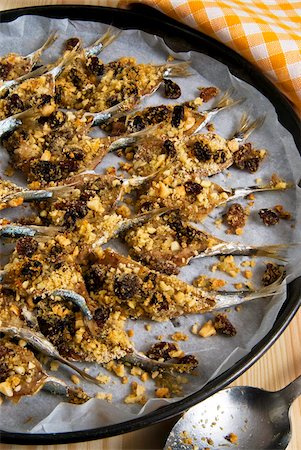 sicily food - Sicilian style anchovies, with crushed almonds, raisin, grated bread, seeds of wild fennel, olive oil, pepper, cooked in the oven, Sicily, Italy, Europe Stock Photo - Rights-Managed, Code: 841-05784029