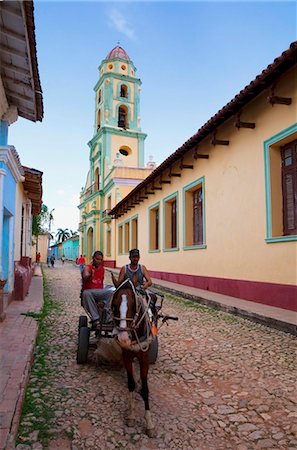 Two men on horse-drawn cart travelling along a quiet street in Trinidad, Sancti Spiritus Province, Cuba, West Indies, Caribbean, Central America Stock Photo - Rights-Managed, Code: 841-05784617