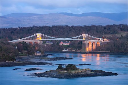 The Menai Bridge spanning the Menai Strait, backed by the mountains of Snowdonia National Park, Wales, United Kingdom, Europe Stock Photo - Rights-Managed, Code: 841-05785071