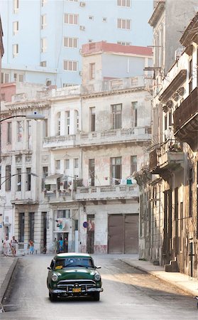 simsearch:841-03672982,k - Classic American car taxi driving down quiet street in Havana Centro, Havana, Cuba, West Indies, Central America Stock Photo - Rights-Managed, Code: 841-05781375