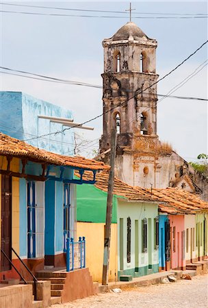 Street scene showing houses painted in bright colours and the ruins of an old church, Trinidad, UNESCO World Heritage Site, Cuba, West Indies, Central America Stock Photo - Rights-Managed, Code: 841-05781397