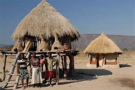 Ttraditional thatch roofed house and grain storage, Lake Kariba, Zimbabwe, Africa Stock Photo - Rights-Managed, Code: 841-05781770