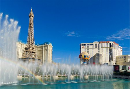 Rainbow produced by the dancing water fountains of the Bellagio hotel with Planet Hollywood hotel, and Paris Hotel with the Eiffel tower, The Strip, Las Vegas Boulevard South, Las Vegas, Nevada, United States of America, North America Stock Photo - Rights-Managed, Code: 841-05782317