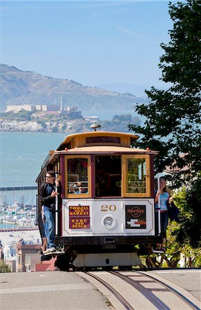 One of the famous cable cars on the Powell-Hyde track, with the island prison of Alcatraz in the background, San Francisco, California, United States of America, North America Stock Photo - Rights-Managed, Code: 841-05782402