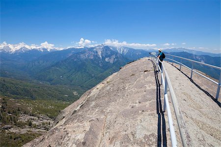 Tourist hiker, on top of Moro Rock overlooking the Sequoia foothills, looking towards Kings Canyon and the high mountains of the Sierra Nevada, Sequoia National Park, California, United States of America, North America Stock Photo - Rights-Managed, Code: 841-05782457