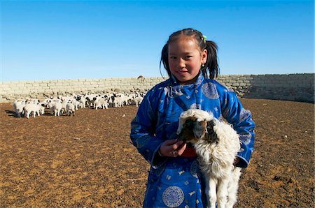 Young Mongolian girl in traditional costume (deel) with her sheep, Province of Khovd, Mongolia, Central Asia, Asia Stock Photo - Rights-Managed, Code: 841-05796501