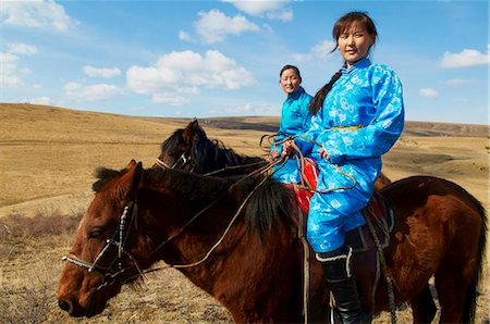 simsearch:841-05796510,k - Young Mongolian women in traditional costume (deel) riding horses, Province of Khovd, Mongolia, Central Asia, Asia Stock Photo - Rights-Managed, Code: 841-05796517