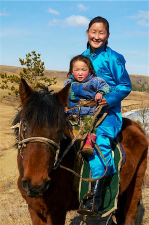 Young Mongolian woman and child in traditional costume (deel) riding a horse, Province of Khovd, Mongolia, Central Asia, Asia Stock Photo - Rights-Managed, Code: 841-05796518