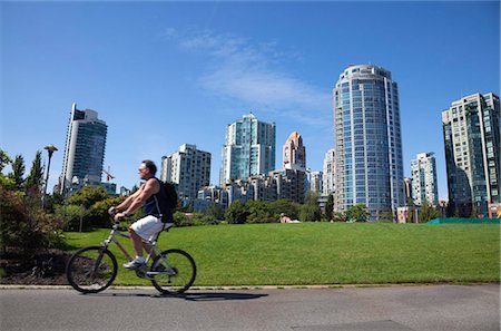 placing - Cyclist passing apartment blocks, False Creek, Vancouver, British Columbia, Canada, North America Stock Photo - Rights-Managed, Code: 841-05846335