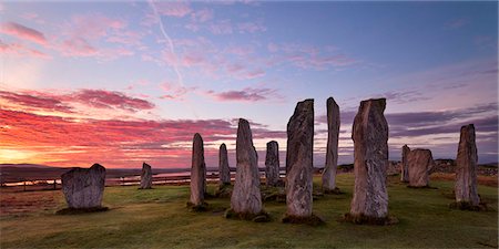 sunrise island - Fiery clouds above the standing stones of Callanish at sunrise in autumn, Island of Lewis, Outer Hebrides, Scotland, United Kingdom, Europe Stock Photo - Rights-Managed, Code: 841-05848777