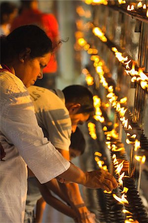 sunset interior - Devotee lighting candles at sunset in the Temple of the Sacred Tooth Relic (Temple of the Tooth), site of Buddhist pilgrimage, Kandy, Sri Lanka, Asia Stock Photo - Rights-Managed, Code: 841-05962849