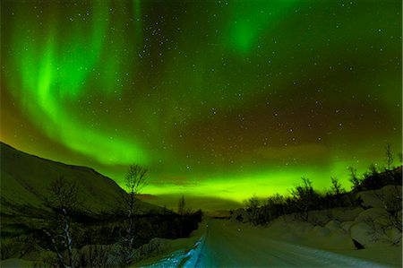 photo of snow covered road at night - Aurora borealis (Northern Lights) seen over a snow covered road, Troms, North Norway, Scandinavia, Europe Stock Photo - Rights-Managed, Code: 841-06030769