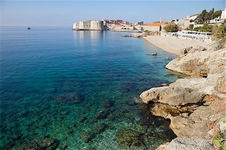 View of Old Town Dubrovnik with rocky coast, Dubrovnik, Croatia, Europe Stock Photo - Rights-Managed, Code: 841-06031173