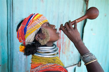 Bonda tribeswoman in traditional costume with beaded cap, large earrings and metal necklaces drinking village alcohol from gourd, Rayagader, Orissa, India, Asia Stock Photo - Rights-Managed, Code: 841-06031734