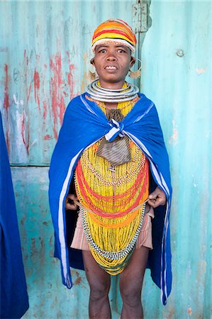 Bonda tribeswoman wearing blue cotton shawl over traditional bead costume, with beaded cap, large earrings and metal necklaces, Rayagader, Orissa, India, Asia Stock Photo - Rights-Managed, Code: 841-06031735