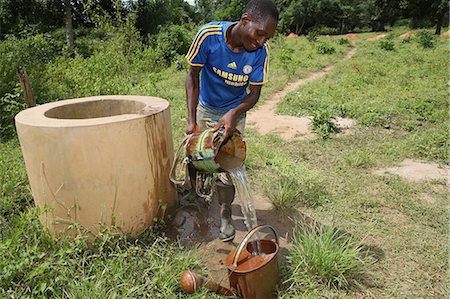 Man fetching water from well, Tori, Benin, West Africa, Africa Stock Photo - Rights-Managed, Code: 841-06032038