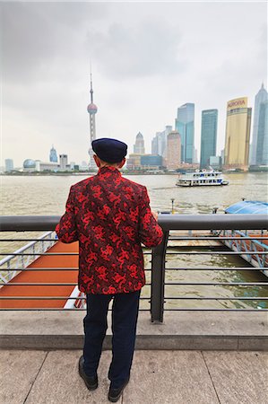 A man looking at the Pudong skyline from the Bund across the Huangpu River, Shanghai, China, Asia Stock Photo - Rights-Managed, Code: 841-06032033