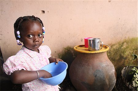 serious african people portrait - Girl eating a meal, Lome, Togo, West Africa, Africa Stock Photo - Rights-Managed, Code: 841-06032416