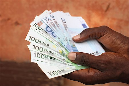 euro photography - African holding Euros, Lome, Togo, West Africa, Africa Stock Photo - Rights-Managed, Code: 841-06032425