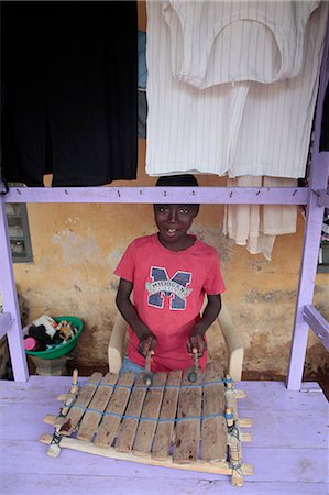 African boy playing music, Lome, Togo, West Africa, Africa Fotografie stock - Rights-Managed, Codice: 841-06032448