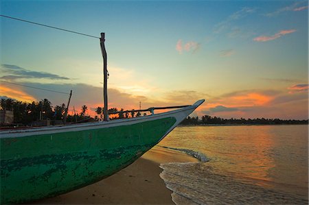 simsearch:841-06499908,k - Outrigger boat at sunset at this fishing beach and popular tourist surf destination, Arugam Bay, Eastern Province, Sri Lanka, Asia Stock Photo - Rights-Managed, Code: 841-06032717