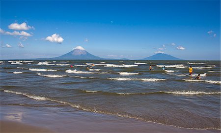 Ometepe Island and swimmers in Lake Nicaragua, Nicaragua, Central America Stock Photo - Rights-Managed, Code: 841-06033902