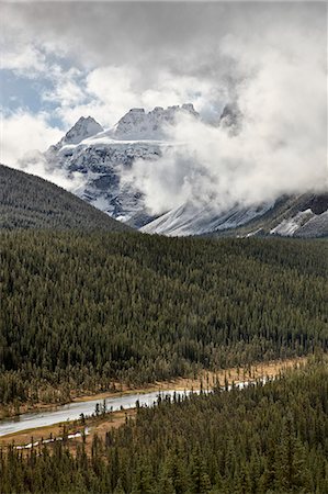simsearch:841-06342593,k - Snow-covered mountains among the clouds above an evergreen forest, Banff National Park, UNESCO World Heritage Site, Alberta, Canada, North America Stock Photo - Rights-Managed, Code: 841-06342618