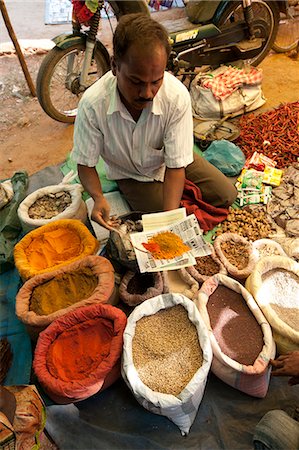 Spice stall at Desia Kondh tribal market, man spooning turmeric, cumin and chilli powder for customer, near Rayagada, Orissa, India, Asia Stock Photo - Rights-Managed, Code: 841-06343903