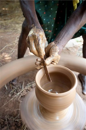 simsearch:841-06343908,k - Hands of village potter using tool to shape clay pot on spinning wheel in his village workshop, near Rayagada, Orissa, India, Asia Foto de stock - Con derechos protegidos, Código: 841-06343911