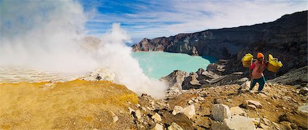 Panorama of sulphur worker appearing out of toxic fumes at Kawah Ijen volcano, East Java, Indonesia, Southeast Asia, Asia Stock Photo - Rights-Managed, Code: 841-06445014