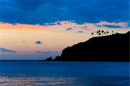 Silhouette of palm trees on a cliff at sunset, Nippah Beach, Lombok, Indonesia, Southeast Asia, Asia Stock Photo - Rights-Managed, Code: 841-06445153