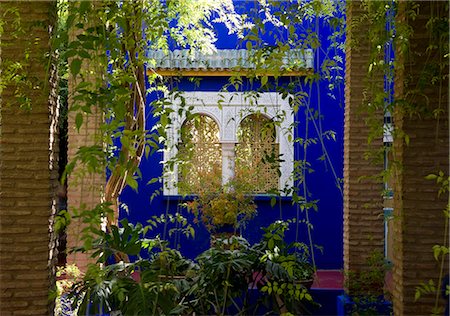 A view through a pergola to ornate windows surrounded by colbalt blue walls at the Majorelle Garden in Marrakech, Morocco, North Africa, Africa Stock Photo - Rights-Managed, Code: 841-06445511