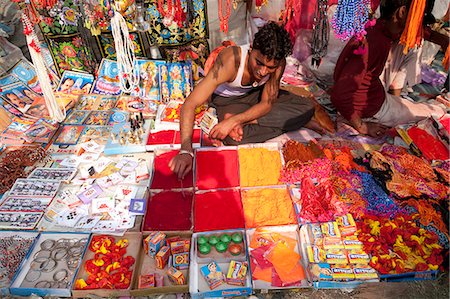 people market - Man selling abir, a red powder used for marking teeka on the forehead, and other Hindu trinkets, Sonepur, Bihar, India, Asia Stock Photo - Rights-Managed, Code: 841-06447654